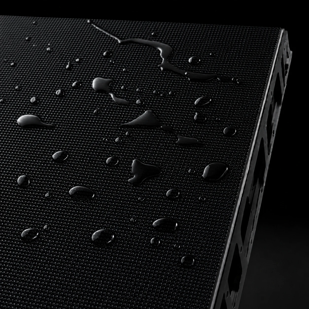 Macro close-up of a black LED module surface with water droplets showing optional GOB protection